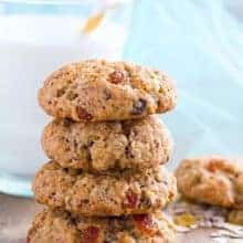 stack of Spicy Oatmeal Raisin Cookies with a glass of milk on background