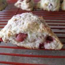 close up of Strawberry Yogurt Scones in red cooling rack showing the inside of it