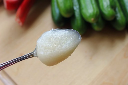 a spoon full of foamy white substance