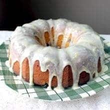 Close up of Greek Yogurt Blueberry Lemon Bundt with Lemon Icing Glaze placed on a green checkered plate