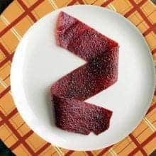 Rhubarb Strawberry Fruit Leather in a middle of a plate with orange design