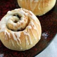 Rum Glazed Mincemeat Cinnamon Buns in red plate