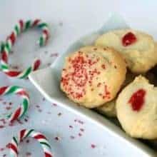 close up Old Fashioned Whipped Shortbread in a white plate, some candy cane on table