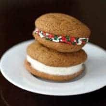 plain and colorful sprinkled Christmas cookies in a white plate