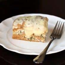 Creamy Chicken Alfredo Crockpot Lasagna in White Plate with Fork