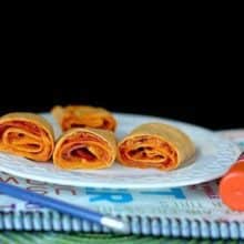 Pepperoni Pizza Rolls in White Plate Over a Notebook