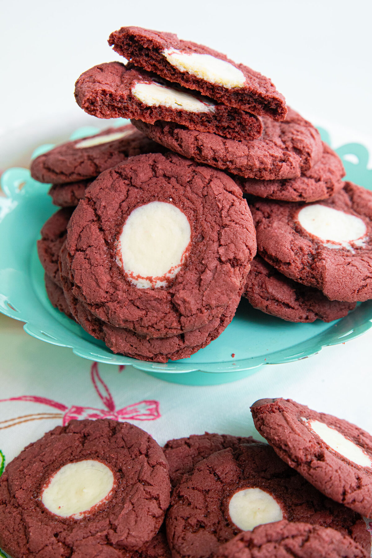Red velvet cheesecake cookies  on a teal cake stand close up