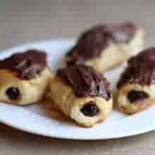 baked eclairs with chocolate pudding in the center and topped with chocolate icing