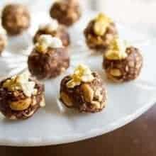 Close up of Peanut Butter Snack Bites with popcorn in a White Cake Holder