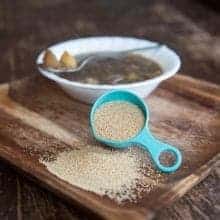 Amaranth Vegetable Soup in a Bowl and a cup of Amaranth Grains in wood tray