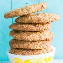 ButOatmeal Scotchies Cookies in a white bowl on jade blue wood background