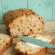 Adding spread to a slice of Butterscotch Oatmeal Banana Bread