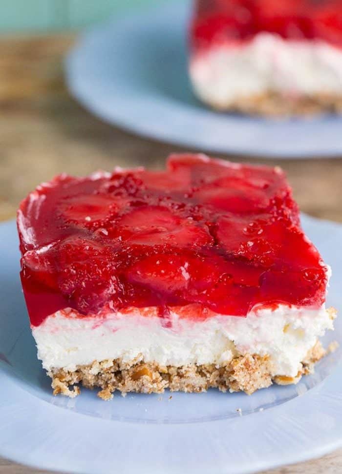 Slice of Strawberry Pretzel Salad in a Pyrex plate