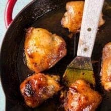 Close up of Five Pieces Sweet Honey Curry Chicken in a Large Red Skillet