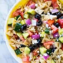 close up Greek Pasta Salad, loaded with mixed olives, cucumber and artichoke