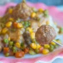 a Meatball in a fork from a plate of Shepherd's Pie