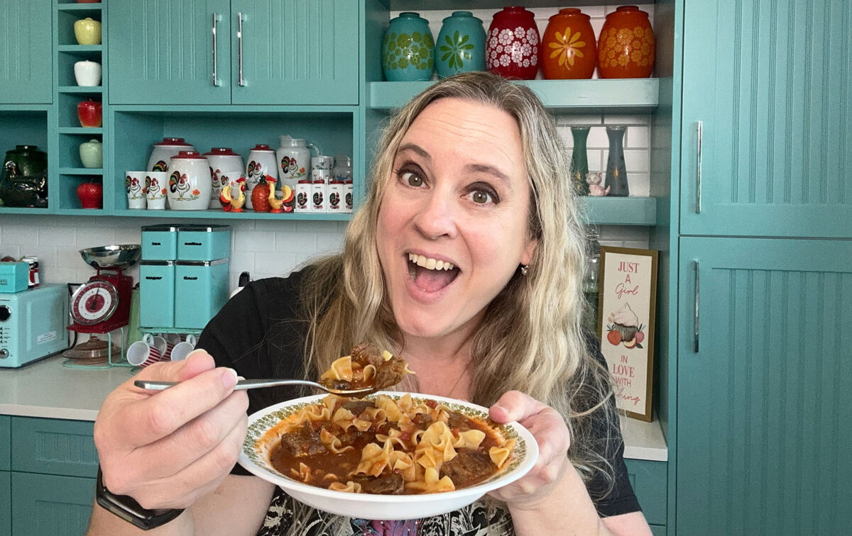 Karlynn holding a bowl of her pasta puttanesca soup