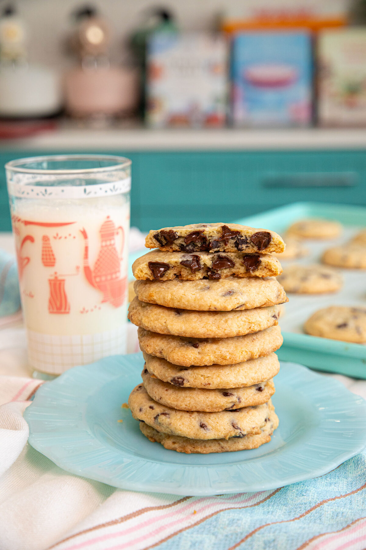 a glass of milk and a stack of cheesecake chocolate chip cookies