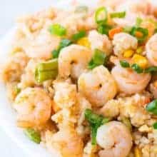 Shrimp Fried Rice in a white bowl topped with chopped green onions