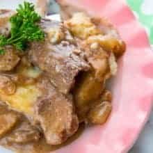 Crockpot Cube Steak served with potatoes in a pink plate