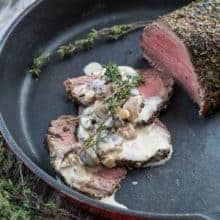 Sliced Tenderloin Roast au Poivre & Mushroom in Red Skillet with Cognac Mushroom Sauce