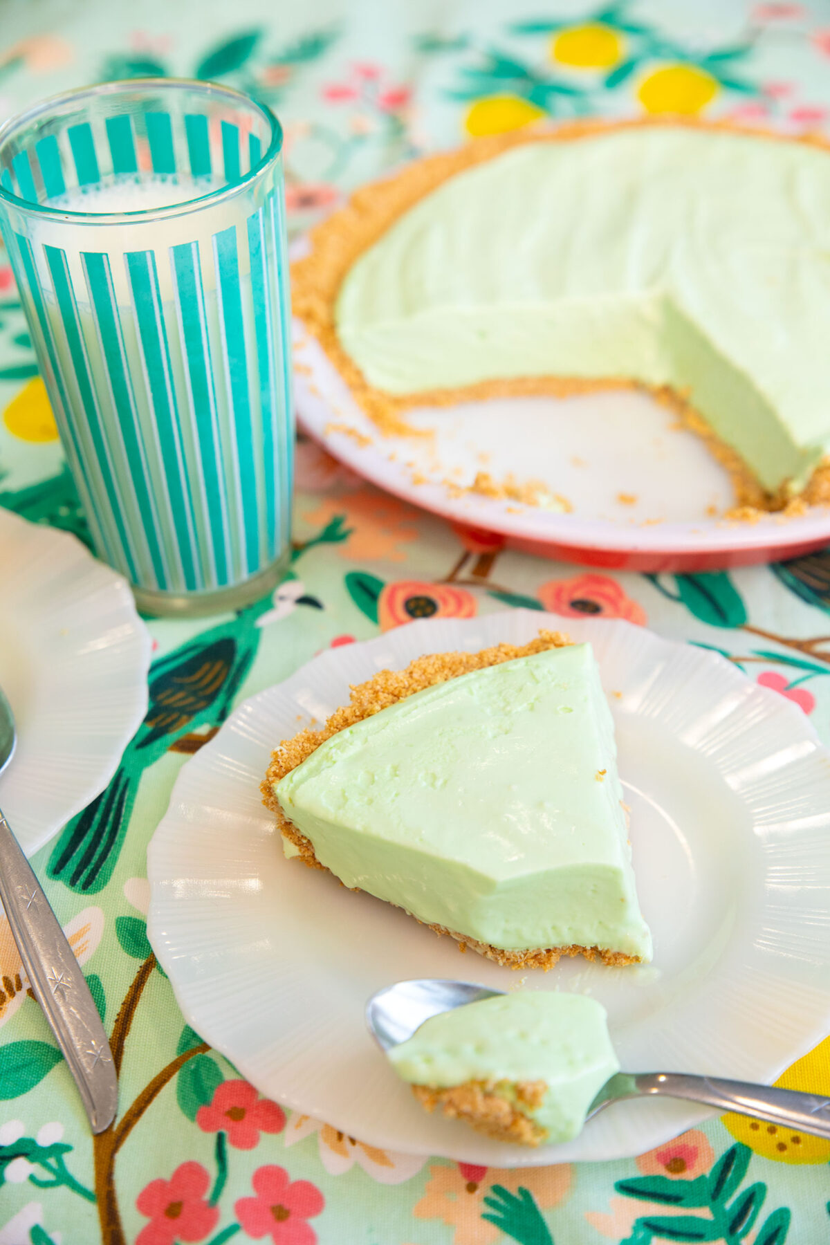 creamy lime pie on a plate with a glass of milk