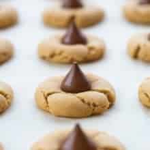 freshly baked cookies with unwrapped Hershey's kiss in the middle