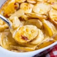 close up of Creamy Cheesy Scalloped Potatoes in a casserole dish