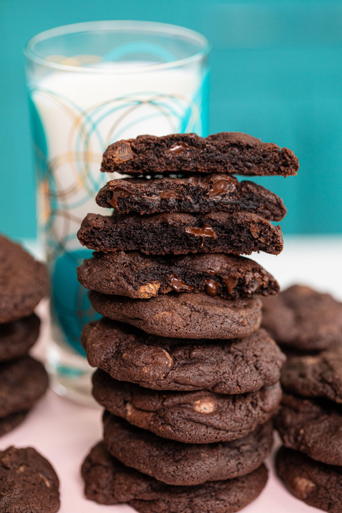  Dark Chocolate Cookies in a tall stack close up view of them broken in half