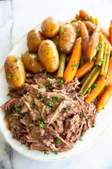 pot roast on a white plate with vegetables