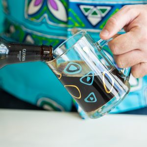 pouring stout (beer) into a beer mug