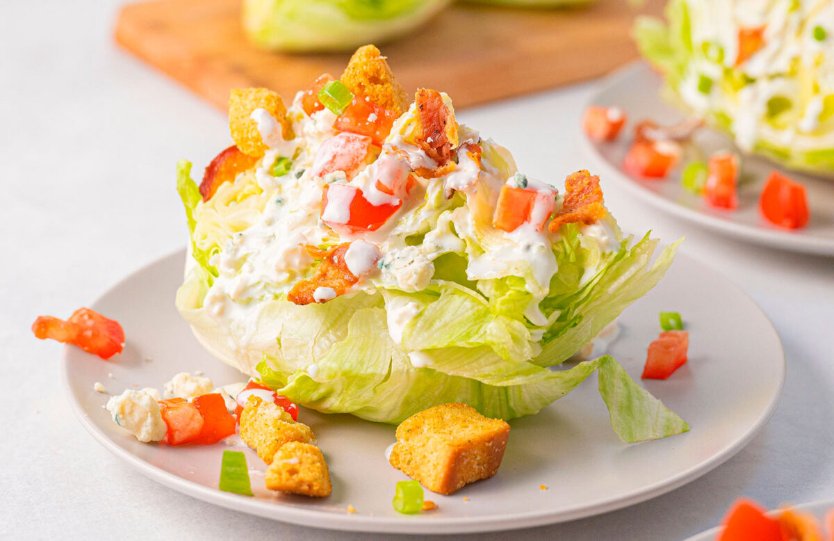 Lettuce with dressing and tomatoes and croutons on top