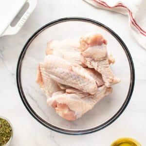 raw turkey wings in a clear bowl