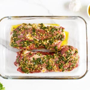 grilled hanger steak uncooked in clear pan