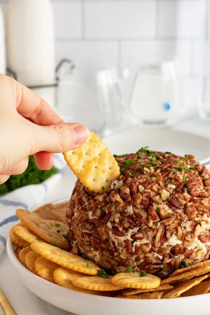 Pineapple Cheese Ball The Kitchen Magpie   Pineapplecheeseballwithahandholdingacracker 700x1050 