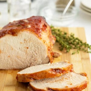 Grilled pork loin sliced on a wooden cutting board