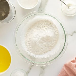 Angel cake dry ingredients in a clear mixing bowl