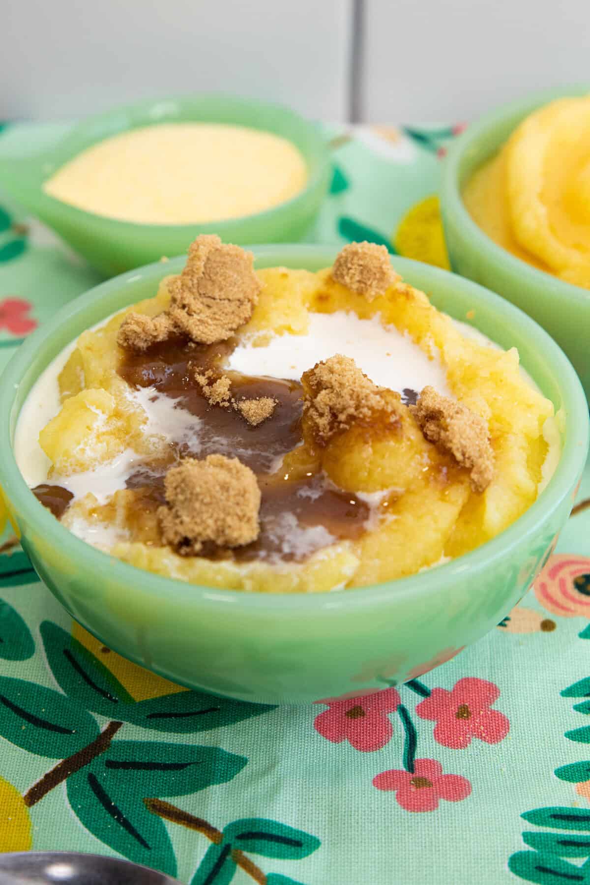 cornmeal porridge or mush in a jadeite bowl with brown sugar and milk on top