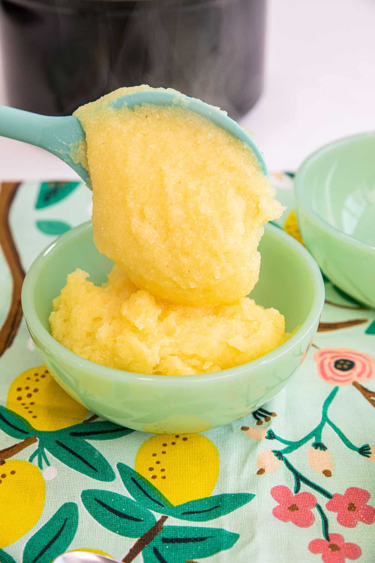 cornmeal mush being spooned into a jadeite bowl