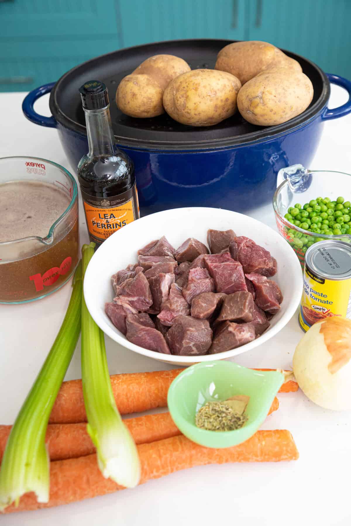 Dutch oven with ingredients around it.