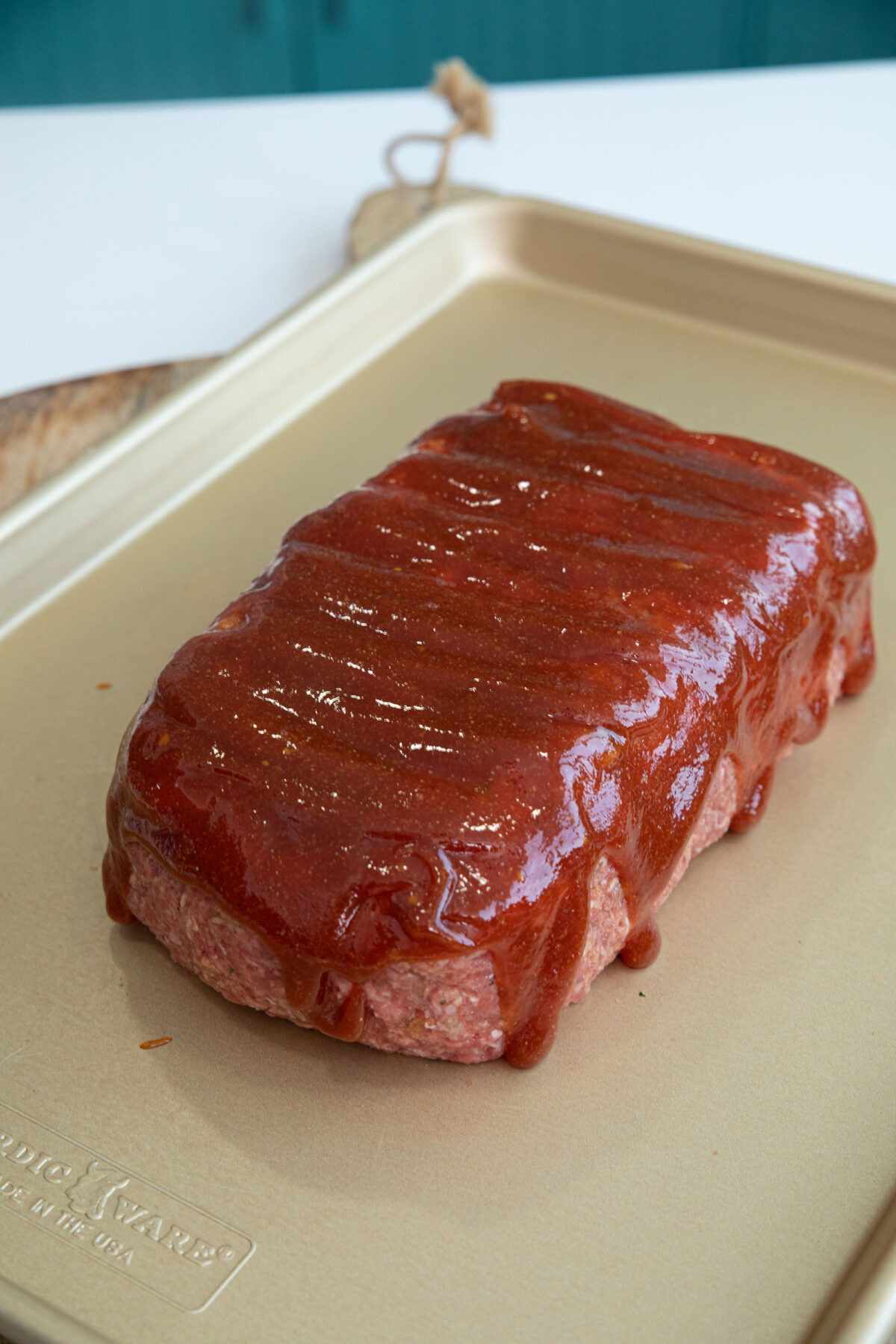 meatloaf sauce brushed onto a stove top stuffing meatloaf