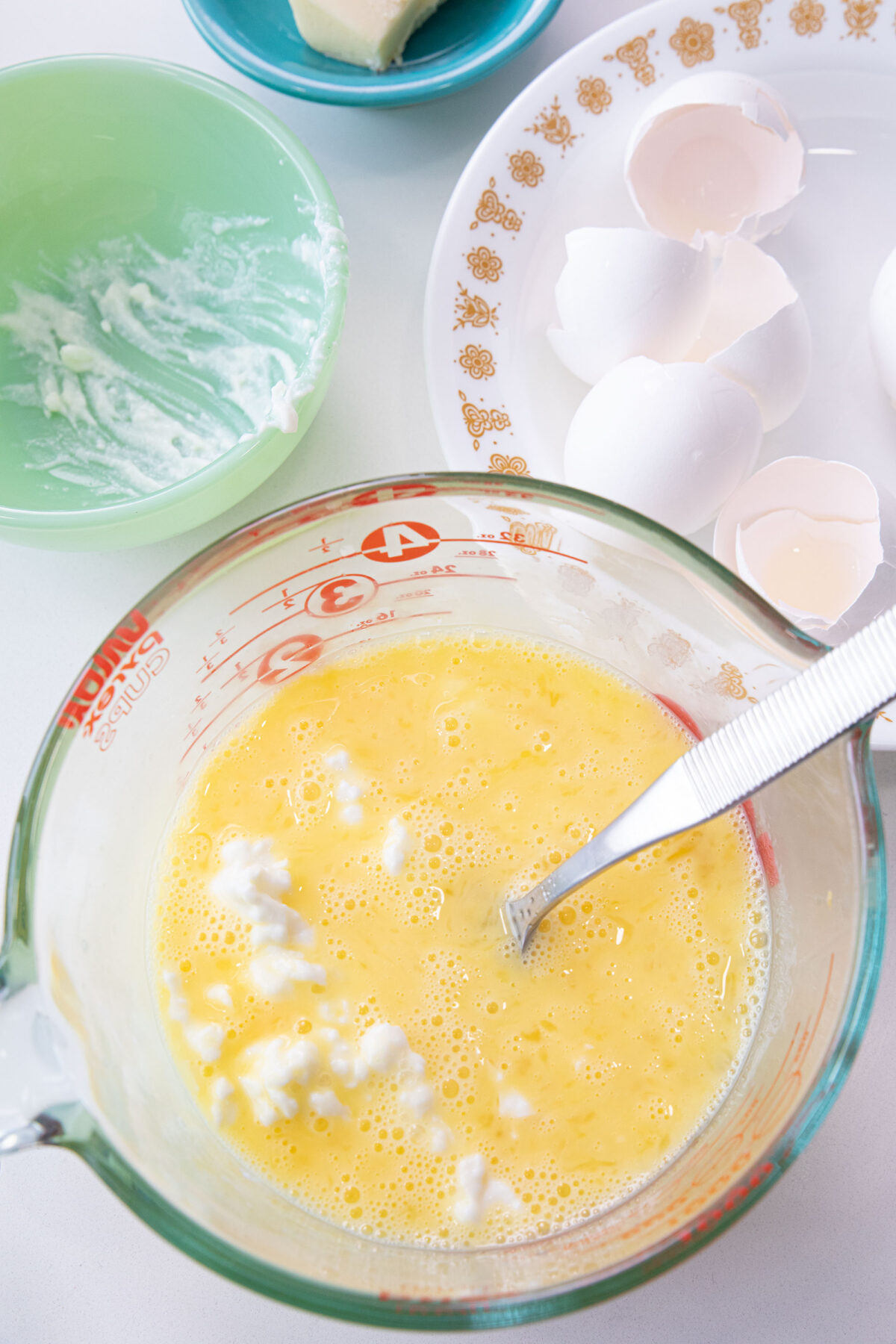 mixing cottage cheese into beaten raw eggs