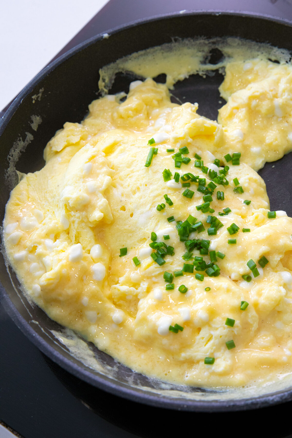 cooking scrambled eggs in a skillet