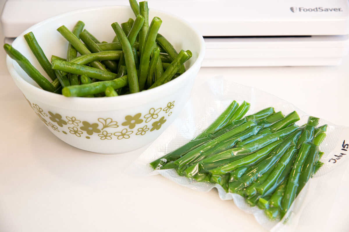 green beans in a bowl and a freezer bag full of green beans