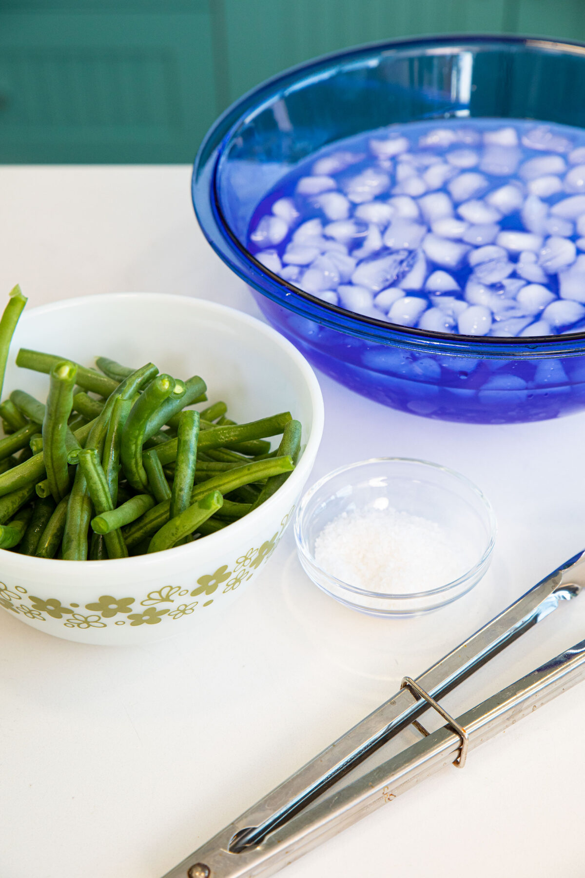 green beans, a bowl of ice water and salt