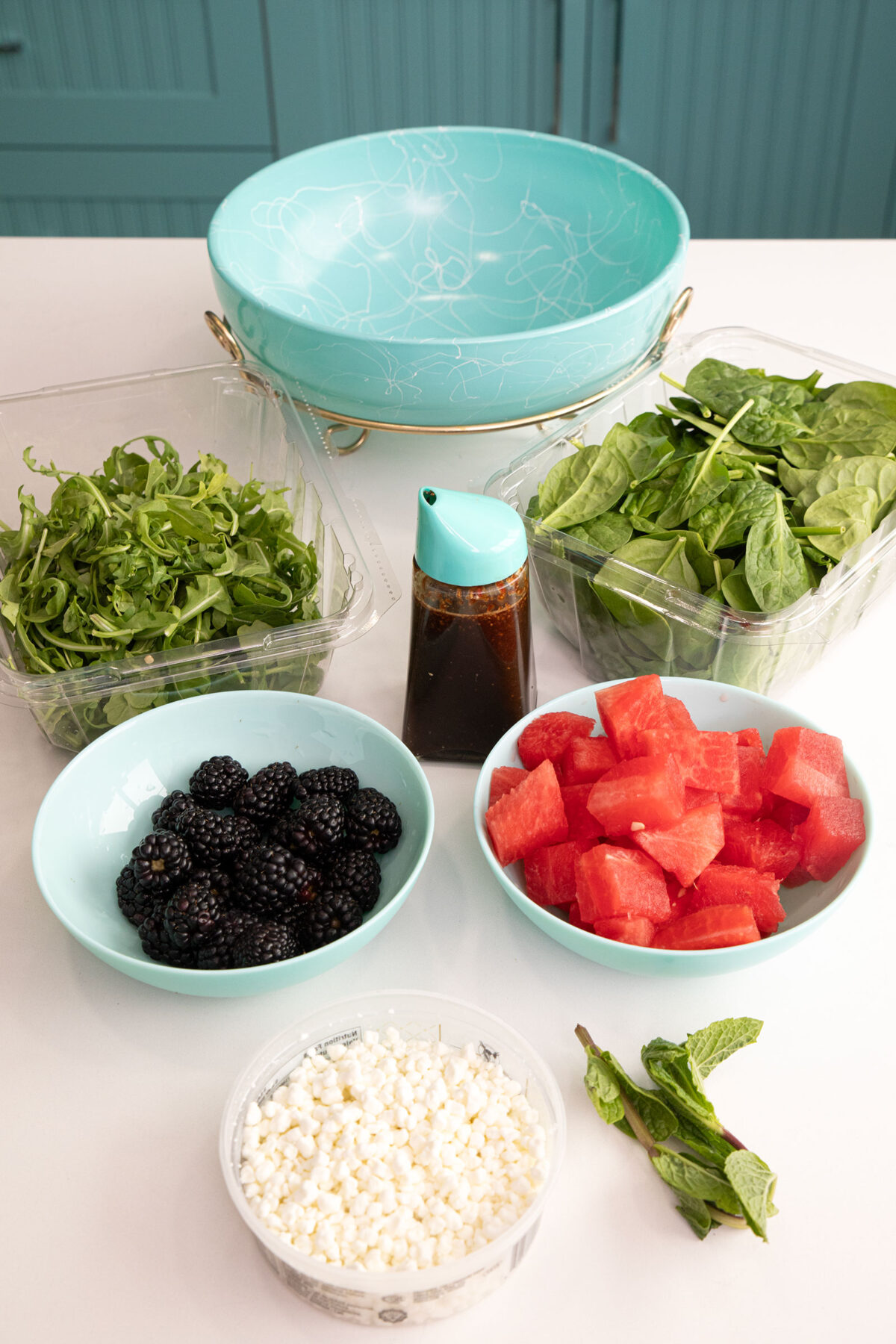 ingredients for the  watermelon salad with feta and mint salad in small bowls