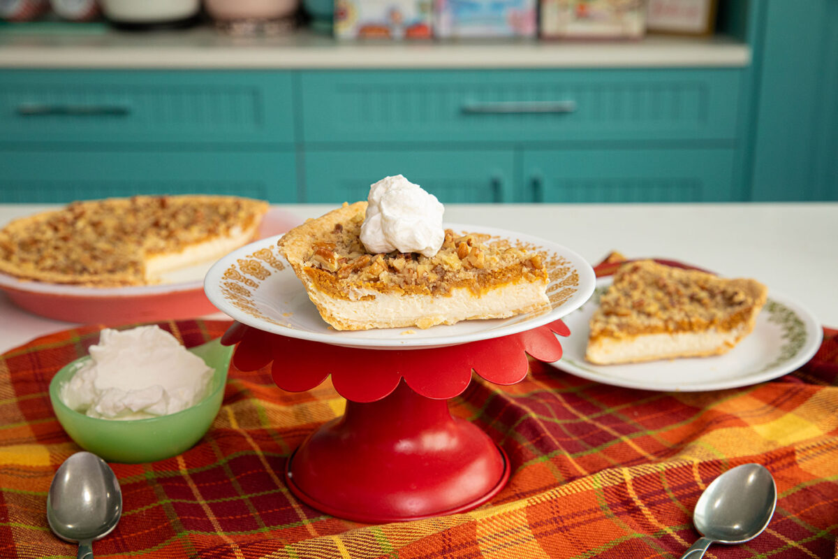 Pumpkin paradise pie on a plate on a red cake stand. 