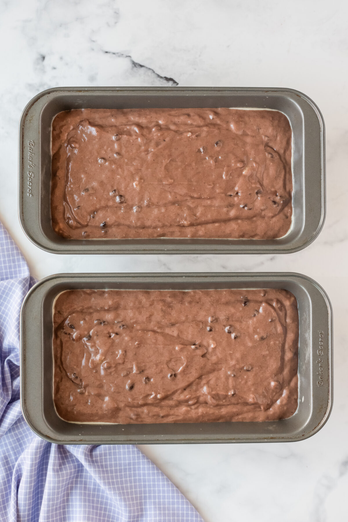 two pans with batter of chocolate banana bread