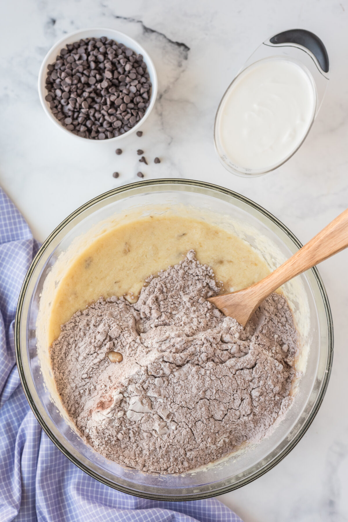 unmixed ingredients of chocolate banana bread in a clear glass bowl 