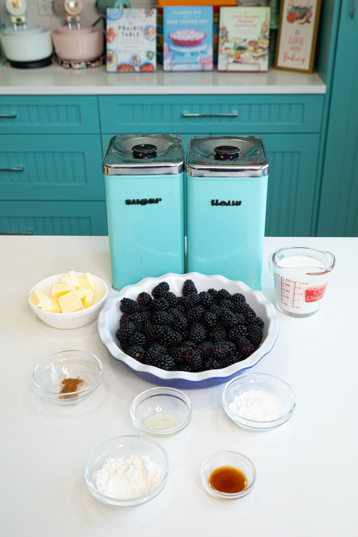 ingredients of blackberry cobbler in small dishes on a counter